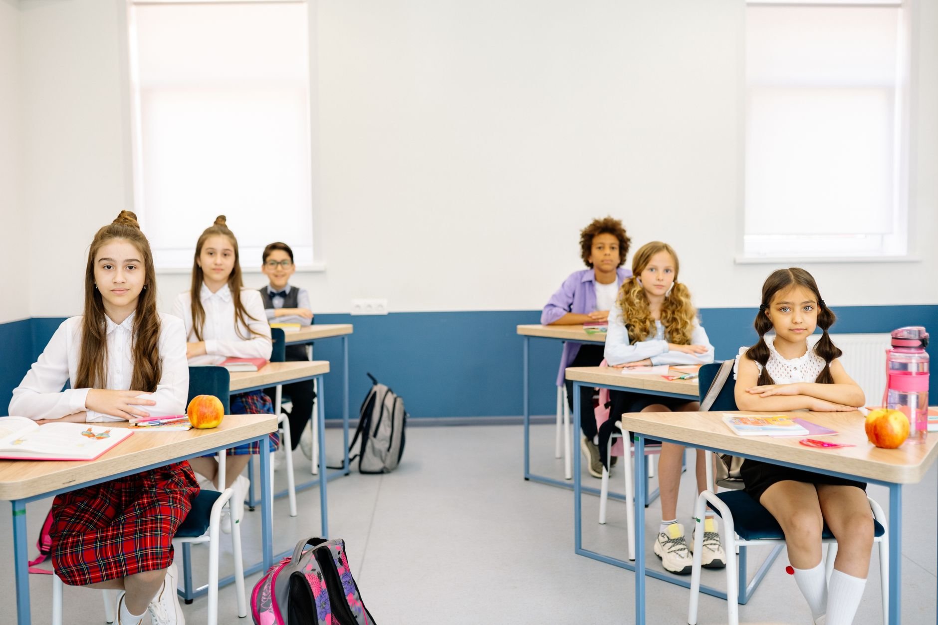 Children attentively studying in a bright classroom, promoting diverse learning environments.
